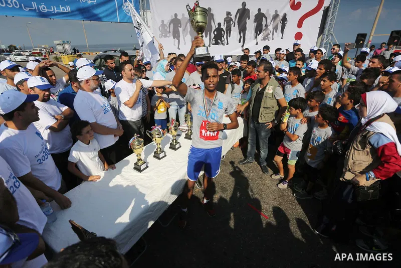 Palestinian youths take part in a marathon to mark the International Youth Day, in Gaza city, on Aug. 12, 2016. Photo by Mohammed Asad