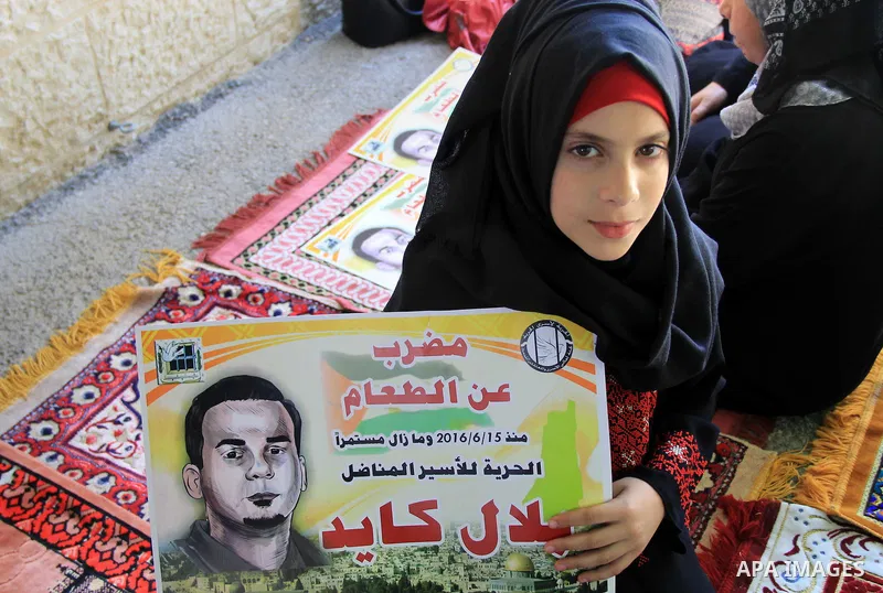 Palestinian protestors hold posters against administrative detention and in support of Palestinian prisoner Bilal Kayed (portrait), who has been fasting for almost two months over his detention without trial, as they dem...
