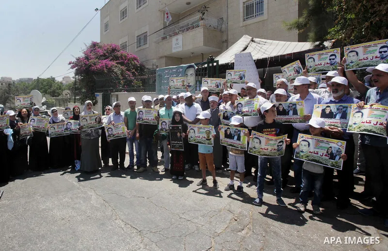 Palestinian protestors hold posters against administrative detention and in support of Palestinian prisoner Bilal Kayed (portrait), who has been fasting for almost two months over his detention without trial, as they dem...