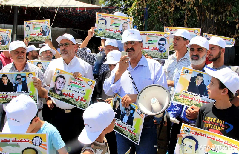 Palestinian protestors hold posters against administrative detention and in support of Palestinian prisoner Bilal Kayed (portrait), who has been fasting for almost two months over his detention without trial, as they dem...