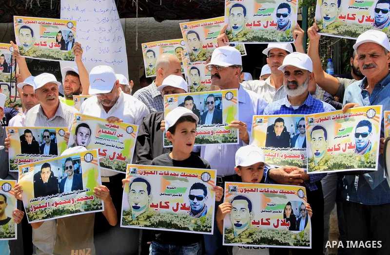 Palestinian protestors hold posters against administrative detention and in support of Palestinian prisoner Bilal Kayed (portrait), who has been fasting for almost two months over his detention without trial, as they dem...