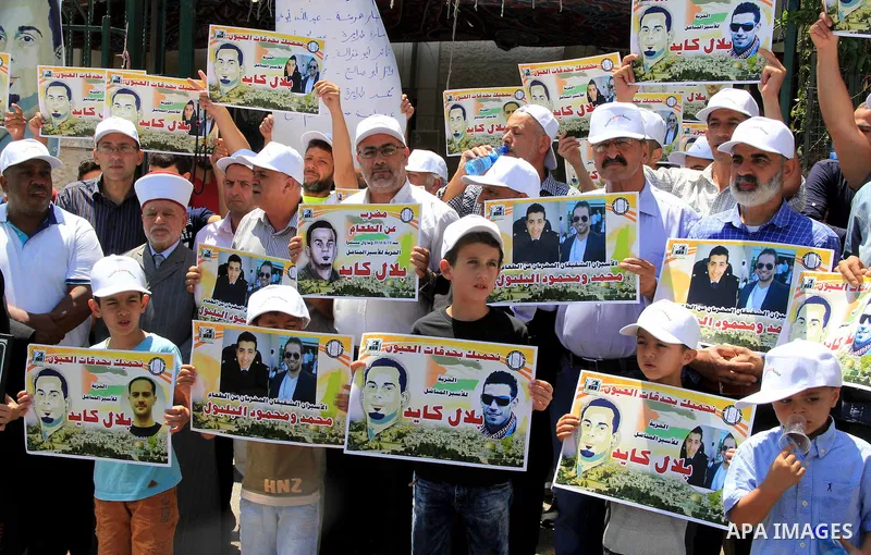Palestinian protestors hold posters against administrative detention and in support of Palestinian prisoner Bilal Kayed (portrait), who has been fasting for almost two months over his detention without trial, as they dem...