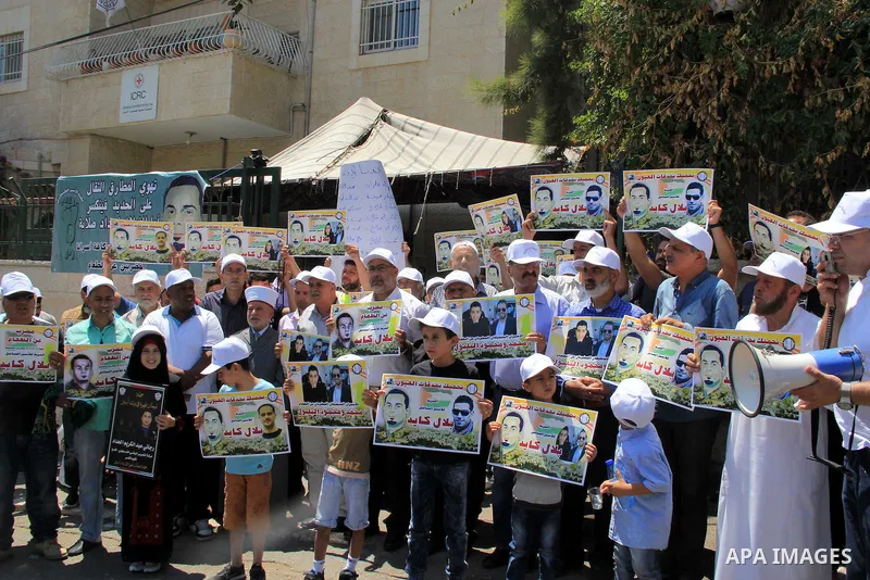 Palestinian protestors hold posters against administrative detention and in support of Palestinian prisoner Bilal Kayed (portrait), who has been fasting for almost two months over his detention without trial, as they dem...