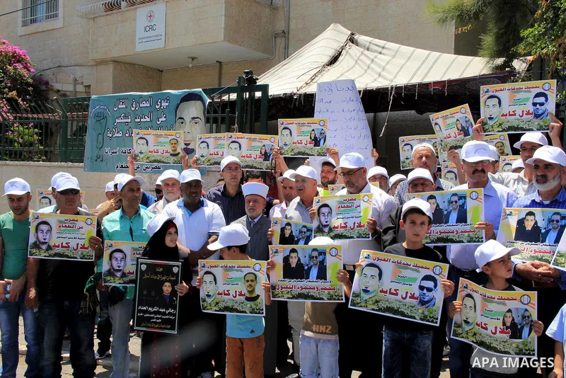 Palestinian protestors hold posters against administrative detention and in support of Palestinian prisoner Bilal Kayed (portrait), who has been fasting for almost two months over his detention without trial, as they dem...