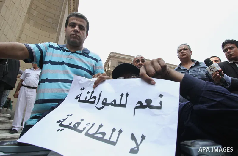 Egyptian Christians hold banners during a protest against Copts in Minya, in front of the High Court in Cairo, Egypt, on August 13, 2016. Photo by Amr Sayed