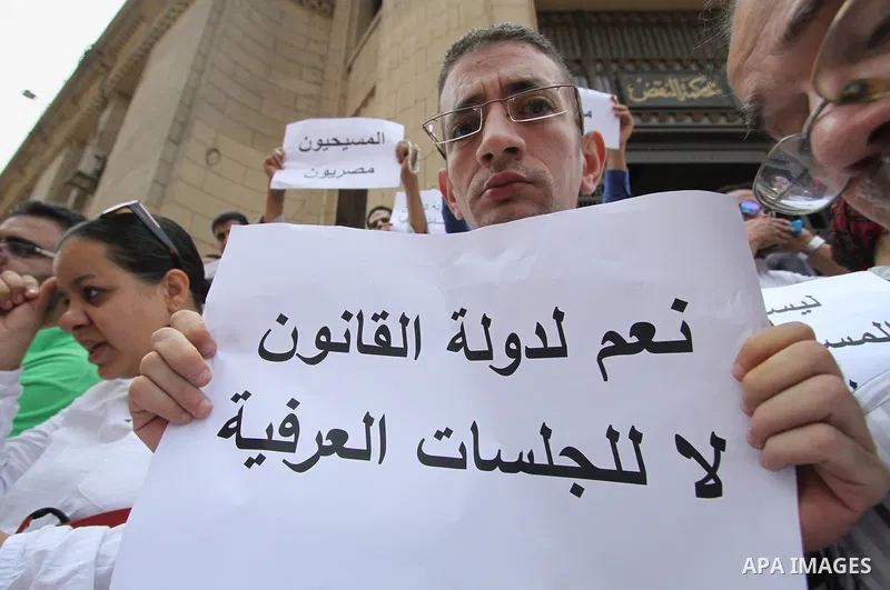 Egyptian Christians hold banners during a protest against Copts in Minya, in front of the High Court in Cairo, Egypt, on August 13, 2016. Photo by Amr Sayed