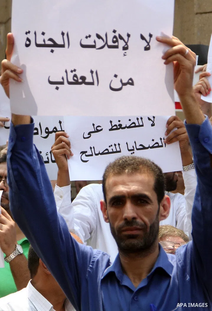 Egyptian Christians hold banners during a protest against Copts in Minya, in front of the High Court in Cairo, Egypt, on August 13, 2016. Photo by Amr Sayed