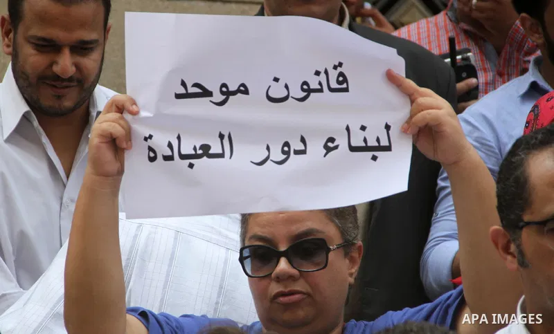 Egyptian Christians hold banners during a protest against Copts in Minya, in front of the High Court in Cairo, Egypt, on August 13, 2016. Photo by Amr Sayed
