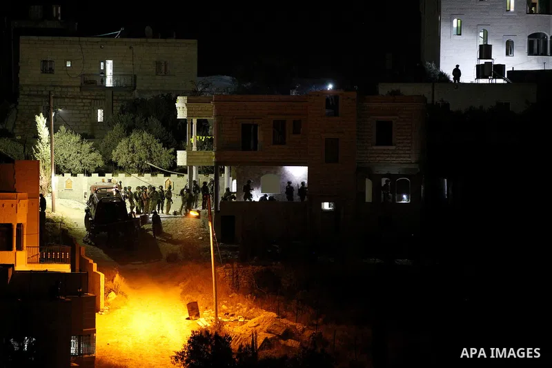 Israeli soldiers set explosives to partially blow up the family house of Palestinian assailant Mohammad Tarayra in the West Bank village of Bani Naem, east of Hebron August 15, 2016. Photo by Wisam Hashlamoun