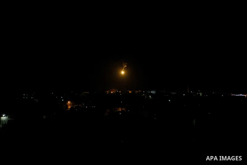 Palestinians put out a fire caused by flares shot by Israeli soldiers as Israeli troops set explosives to partially blow up the family house of Palestinian assailant Mohammad Tarayra in the West Bank village of Bani Naem...