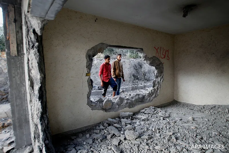 Relatives check the damage to the family house of Palestinian assailant Mohammad Tarayra after it was partially blown up by Israeli troops in the West Bank village of Bani Naem, east of Hebron August 15, 2016. Photo by W...
