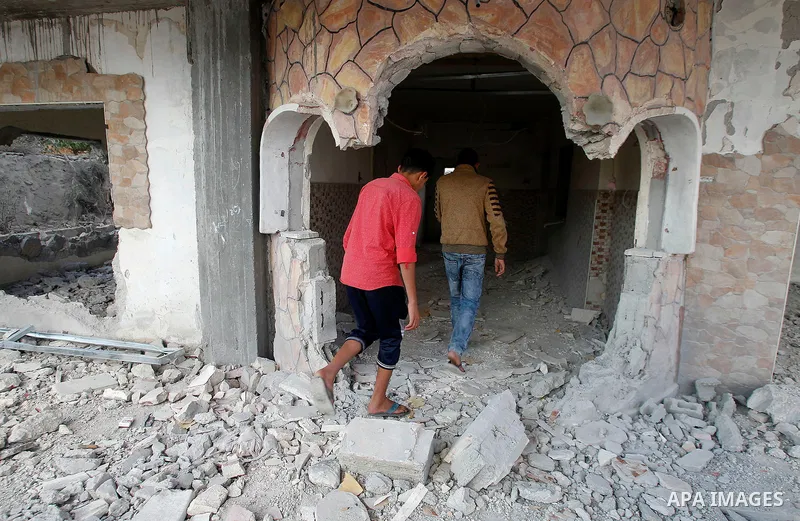 Relatives check the damage to the family house of Palestinian assailant Mohammad Tarayra after it was partially blown up by Israeli troops in the West Bank village of Bani Naem, east of Hebron August 15, 2016. Photo by W...