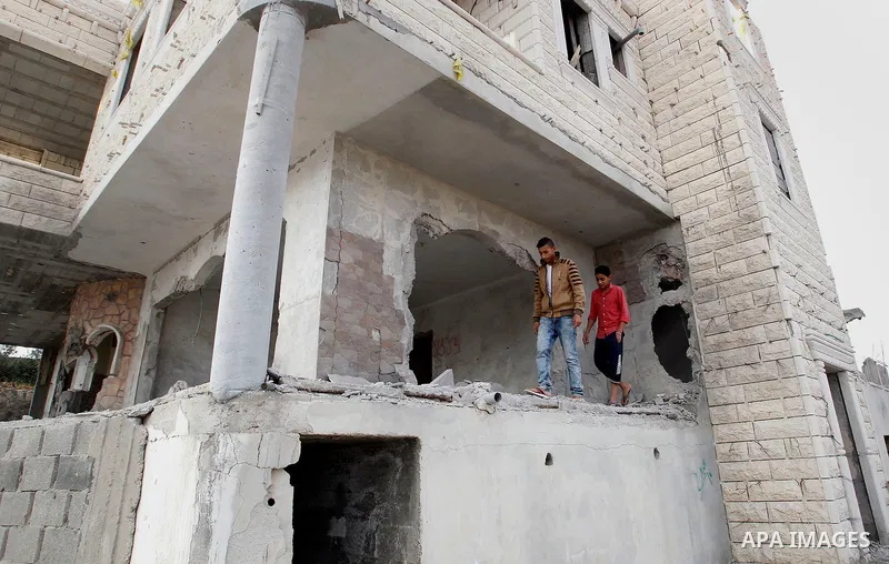 Relatives check the damage to the family house of Palestinian assailant Mohammad Tarayra after it was partially blown up by Israeli troops in the West Bank village of Bani Naem, east of Hebron August 15, 2016. Photo by W...