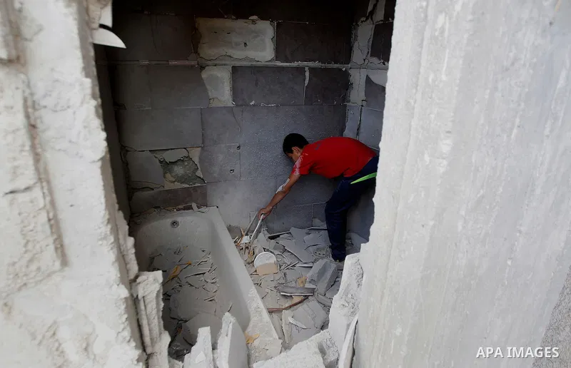 Relatives check the damage to the family house of Palestinian assailant Mohammad Tarayra after it was partially blown up by Israeli troops in the West Bank village of Bani Naem, east of Hebron August 15, 2016. Photo by W...