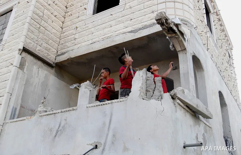 Relatives check the damage to the family house of Palestinian assailant Mohammad Tarayra after it was partially blown up by Israeli troops in the West Bank village of Bani Naem, east of Hebron August 15, 2016. Photo by W...