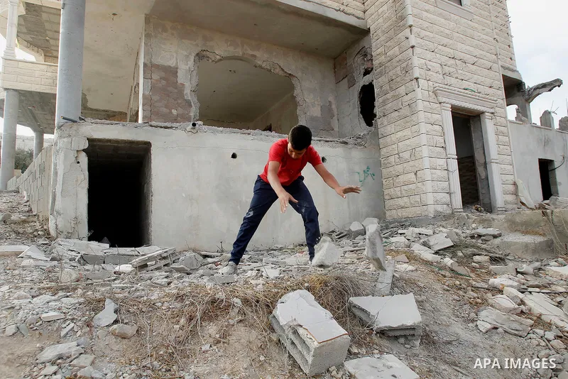 Relatives check the damage to the family house of Palestinian assailant Mohammad Tarayra after it was partially blown up by Israeli troops in the West Bank village of Bani Naem, east of Hebron August 15, 2016. Photo by W...