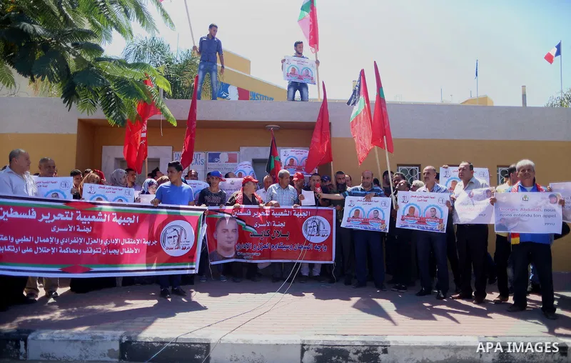 Palestinians hold posters against administrative detention and in support of Palestinian prisoner Bilal Kayed (portrait), who has been fasting for almost two months over his detention without trial, in Gaza city, on Augu...