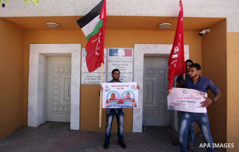 Palestinians hold posters against administrative detention and in support of Palestinian prisoner Bilal Kayed (portrait), who has been fasting for almost two months over his detention without trial, in Gaza city, on Augu...