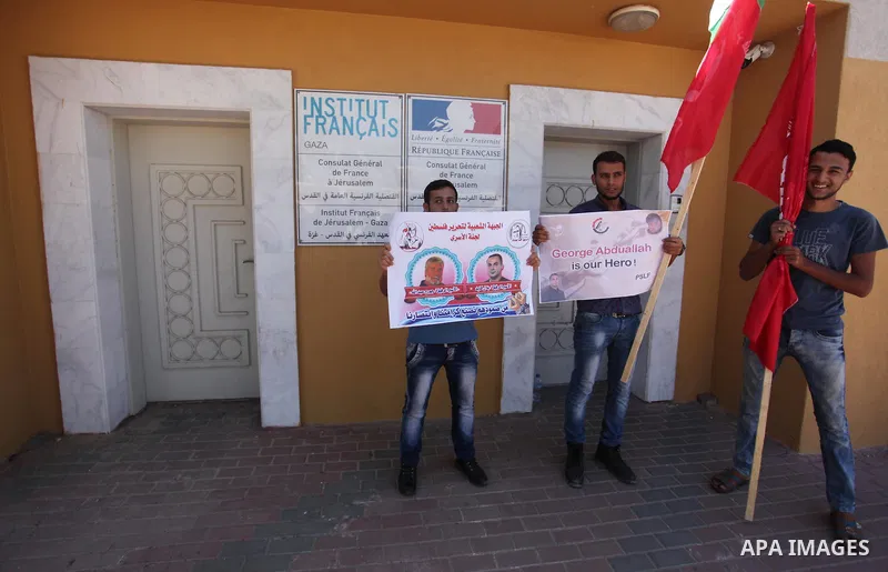 Palestinians hold posters against administrative detention and in support of Palestinian prisoner Bilal Kayed (portrait), who has been fasting for almost two months over his detention without trial, in Gaza city, on Augu...
