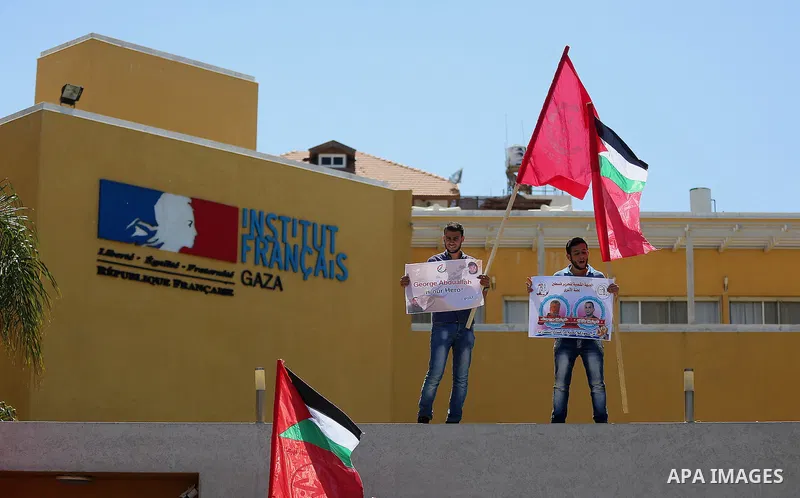 Palestinians hold posters against administrative detention and in support of Palestinian prisoner Bilal Kayed (portrait), who has been fasting for almost two months over his detention without trial, in Gaza city, on Augu...