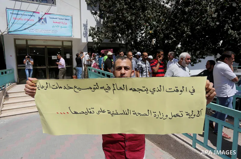 Palestinians from the Al-Bureij refugee camp, take part in protest demanding their rights, in Gaza city, on August 16, 2016. Photo by Mohammed Asad