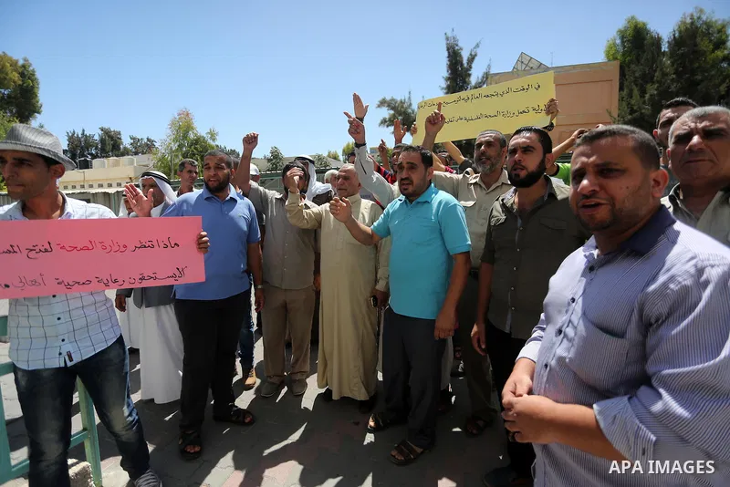 Palestinians from the Al-Bureij refugee camp, take part in protest demanding their rights, in Gaza city, on August 16, 2016. Photo by Mohammed Asad