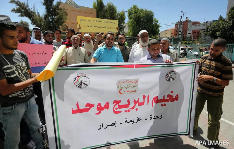Palestinians from the Al-Bureij refugee camp, take part in protest demanding their rights, in Gaza city, on August 16, 2016. Photo by Mohammed Asad