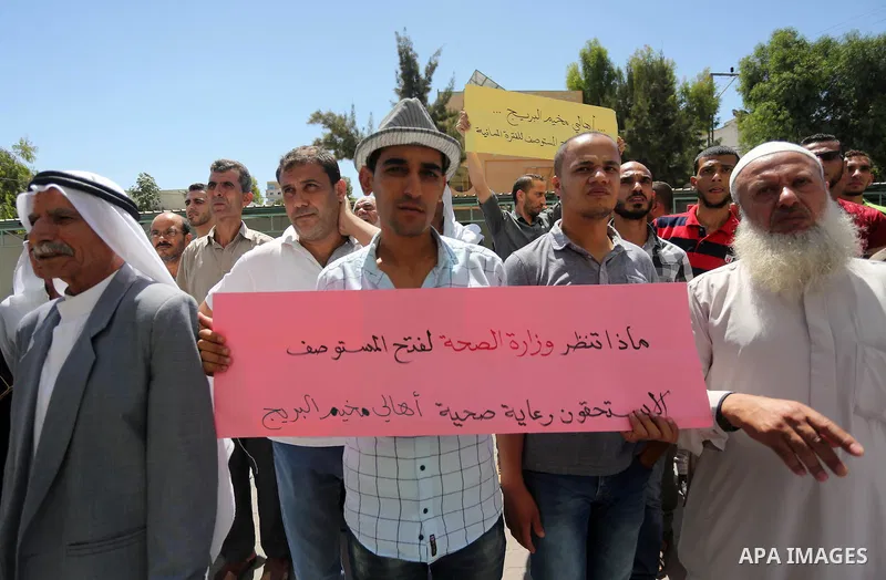 Palestinians from the Al-Bureij refugee camp, take part in protest demanding their rights, in Gaza city, on August 16, 2016. Photo by Mohammed Asad