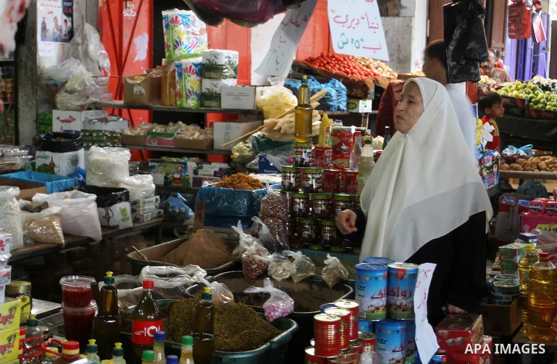 Palestinians shop at a market in Rafah in the southern Gaza strip, on August 16, 2016. Photo by Abed Rahim Khatib
