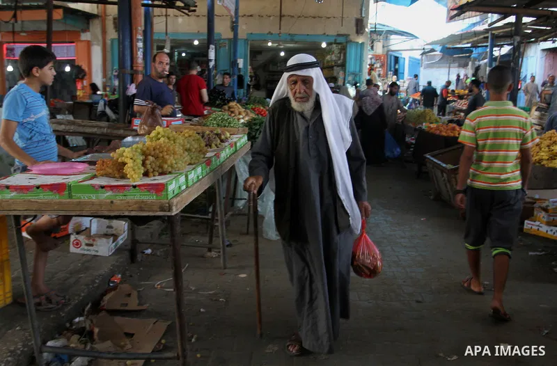 Palestinians shop at a market in Rafah in the southern Gaza strip, on August 16, 2016. Photo by Abed Rahim Khatib