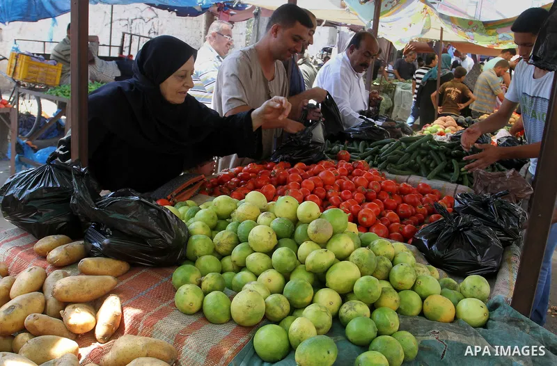 Palestinians shop at a market in Rafah in the southern Gaza strip, on August 16, 2016. Photo by Abed Rahim Khatib