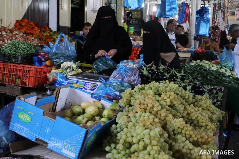 Palestinians shop at a market in Rafah in the southern Gaza strip, on August 16, 2016. Photo by Abed Rahim Khatib