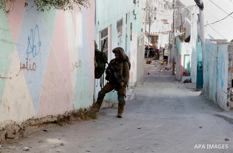 Israeli soldiers conduct searches in the Palestinian al-Fawwar refugee camp, south of the West Bank city of Hebron, on August 16, 2016. Twenty-five Palestinians were wounded in clashes with Israeli soldiers conducting se...