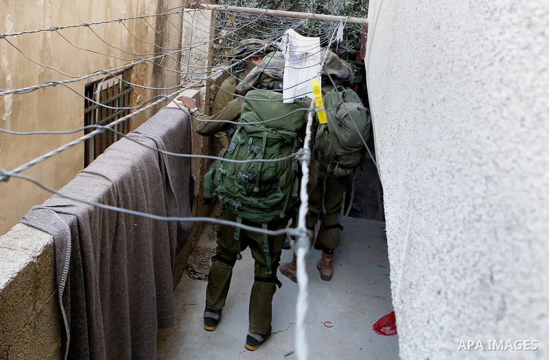 Israeli soldiers conduct searches in the Palestinian al-Fawwar refugee camp, south of the West Bank city of Hebron, on August 16, 2016. Twenty-five Palestinians were wounded in clashes with Israeli soldiers conducting se...