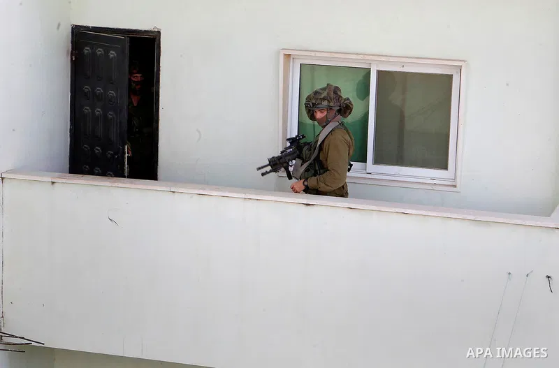 Israeli soldiers conduct searches in the Palestinian al-Fawwar refugee camp, south of the West Bank city of Hebron, on August 16, 2016. Twenty-five Palestinians were wounded in clashes with Israeli soldiers conducting se...