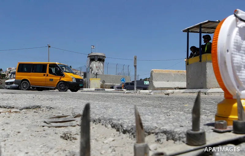 Israeli soldiers stand guard at the main entrance of the Palestinian al-Fawwar refugee camp, south of the West Bank city of Hebron, on August 16, 2016 as the Israeli army conducts searches. Twenty-five Palestinians were...