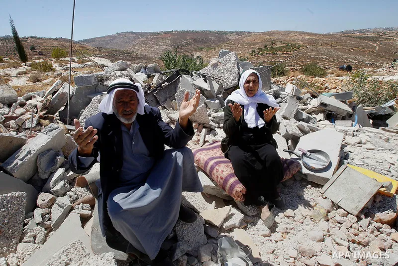 Palestinians react after Israeli troops demolished their house in the West Bank village of Saeer, near Hebron August 16, 2016. Photo by Wisam Hashlamoun