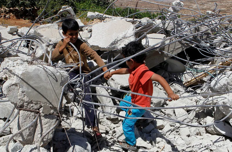 Palestinians check their belongings after Israeli troops demolished their house in the West Bank village of Saeer, near Hebron August 16, 2016. Photo by Wisam Hashlamoun