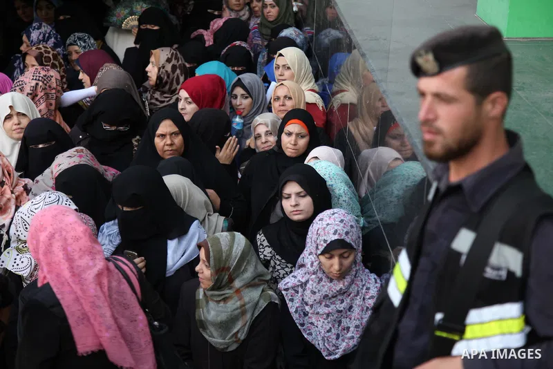 Employees of former Palestinian government in Gaza Strip wait to receive their salaries at a Post Office in Gaza city on August 17, 2016. The Emir of Qatar, Sheikh Tamim bin Hamad al-Thani, has ordered paying a total of...