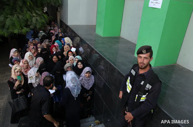 Employees of former Palestinian government in Gaza Strip wait to receive their salaries at a Post Office in Gaza city on August 17, 2016. The Emir of Qatar, Sheikh Tamim bin Hamad al-Thani, has ordered paying a total of...