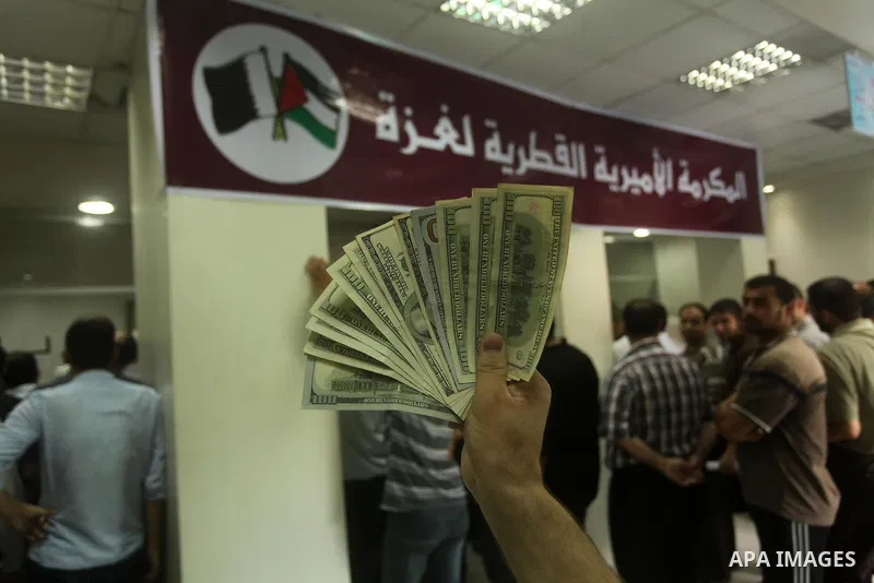Employees of former Palestinian government in Gaza Strip wait to receive their salaries at a Post Office in Gaza city on August 17, 2016. The Emir of Qatar, Sheikh Tamim bin Hamad al-Thani, has ordered paying a total of...