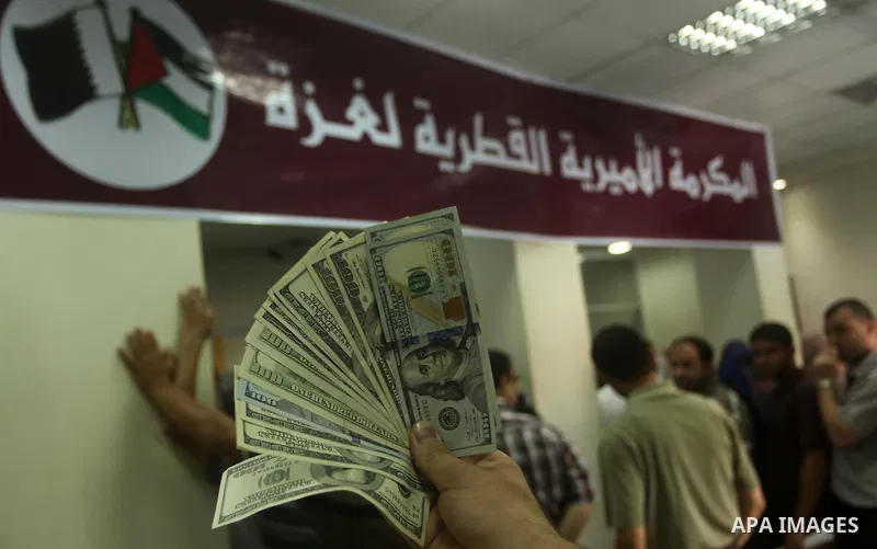 Employees of former Palestinian government in Gaza Strip wait to receive their salaries at a Post Office in Gaza city on August 17, 2016. The Emir of Qatar, Sheikh Tamim bin Hamad al-Thani, has ordered paying a total of...