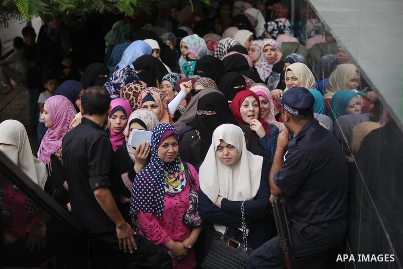 Employees of former Palestinian government in Gaza Strip wait to receive their salaries at a Post Office in Gaza city on August 17, 2016. The Emir of Qatar, Sheikh Tamim bin Hamad al-Thani, has ordered paying a total of...