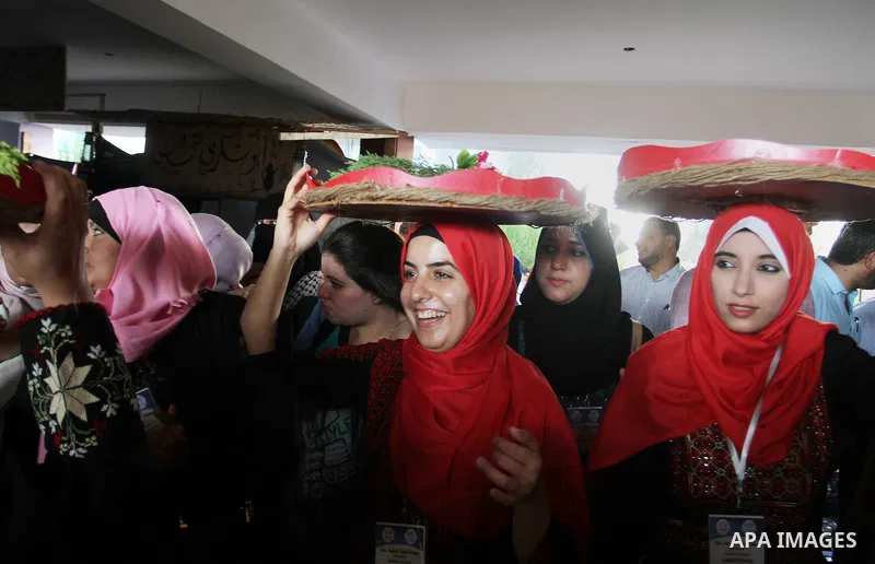 Palestinians take part in heritage festival during the closing ceremony of 2016 summer fun week organised by the United Nations Relief and Works Agency (UNRWA), in Khan Younis in the southern Gaza strip, on August 17, 20...