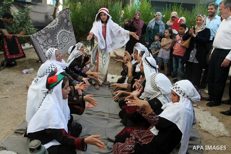 Palestinians take part in heritage festival during the closing ceremony of 2016 summer fun week organised by the United Nations Relief and Works Agency (UNRWA), in Khan Younis in the southern Gaza strip, on August 17, 20...