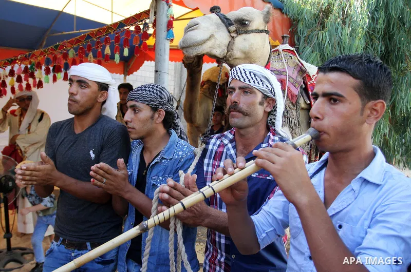 Palestinians take part in heritage festival during the closing ceremony of 2016 summer fun week organised by the United Nations Relief and Works Agency (UNRWA), in Khan Younis in the southern Gaza strip, on August 17, 20...