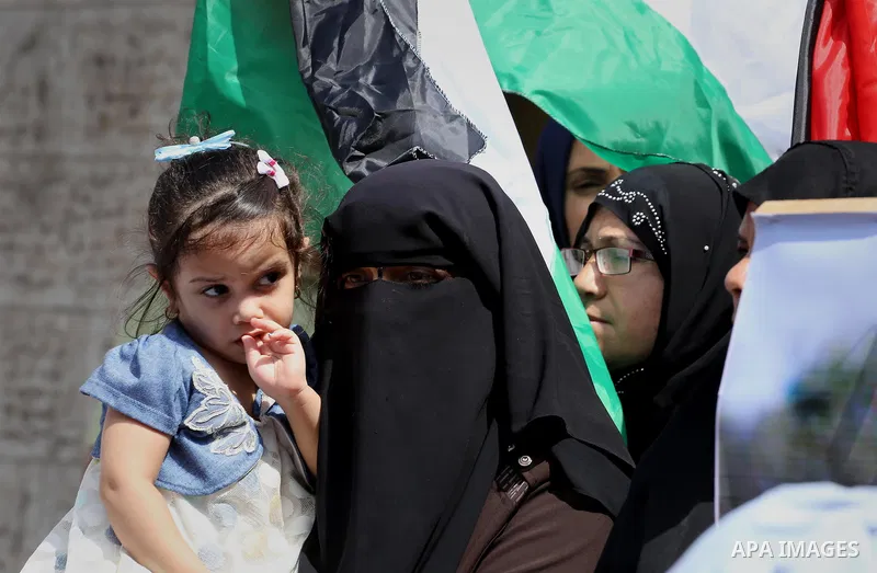 Palestinians hold posters for four men abducted by unidentified masked gunmen on August 19 during a protest demanding for their return, in front of Red Cross office, in August 18, 2016. Photo by Mohammed Asad