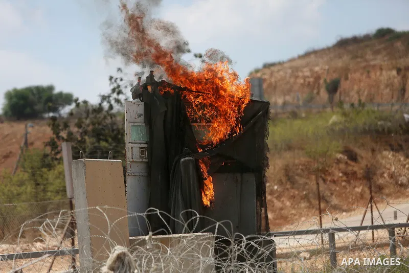 Palestinian protesters clash with Israeli troops following a protest in solidarity with Palestinian prisoners held in Israeli jails, near Israel's Ofer Prison near the West Bank city of Ramallah, August 18, 2016. Photo b...