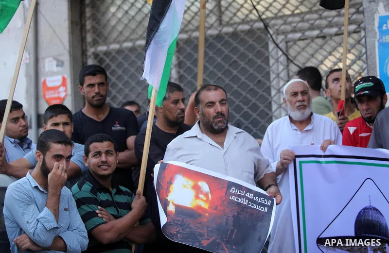 Palestinians take part during a protest to mark the 47th anniversary of the burning of Al-Aqsa Mosque, in Gaza city on Aug. 21, 2016. Photo by Ashraf Amra