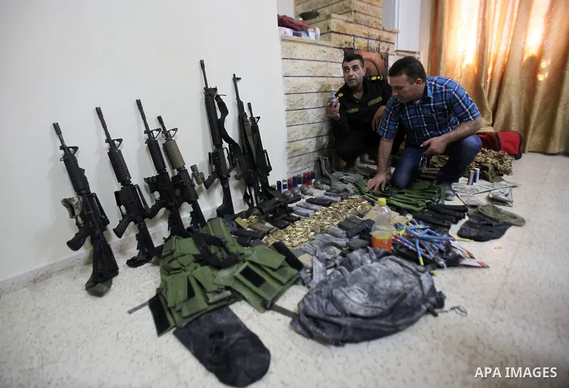 Members of Palestinian security forces inspects weapons and several hand grenades for Palestinian gunmen during operation search in the old city in the west bank city of Nablus August 21, 2016. Palestinian security force...